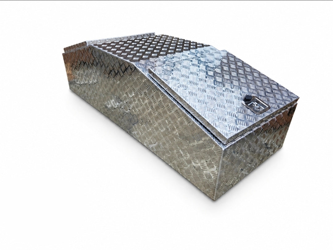 A diamond plate aluminum storage box with a slanted lid and a lock, shown on a plain white background.